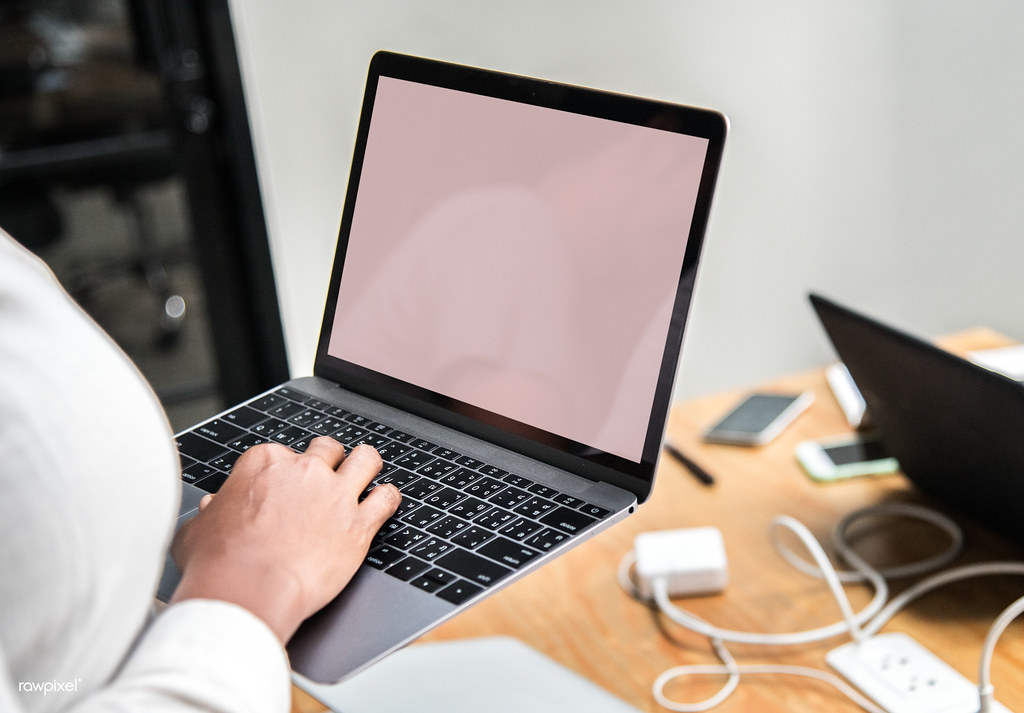 Professional candidate reviewing job search materials on a laptop before applying to senior roles.
